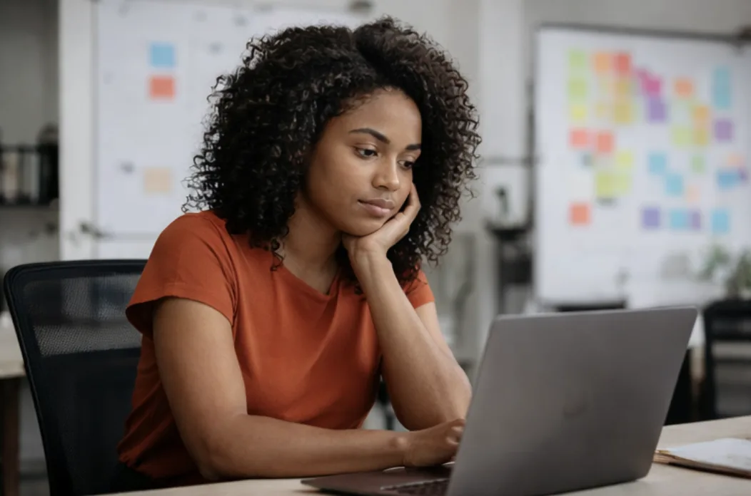 Executive working on a laptop during a virtual image consulting session, representing Taking First's online image consulting for busy professionals seeking flexible, high-impact presence coaching