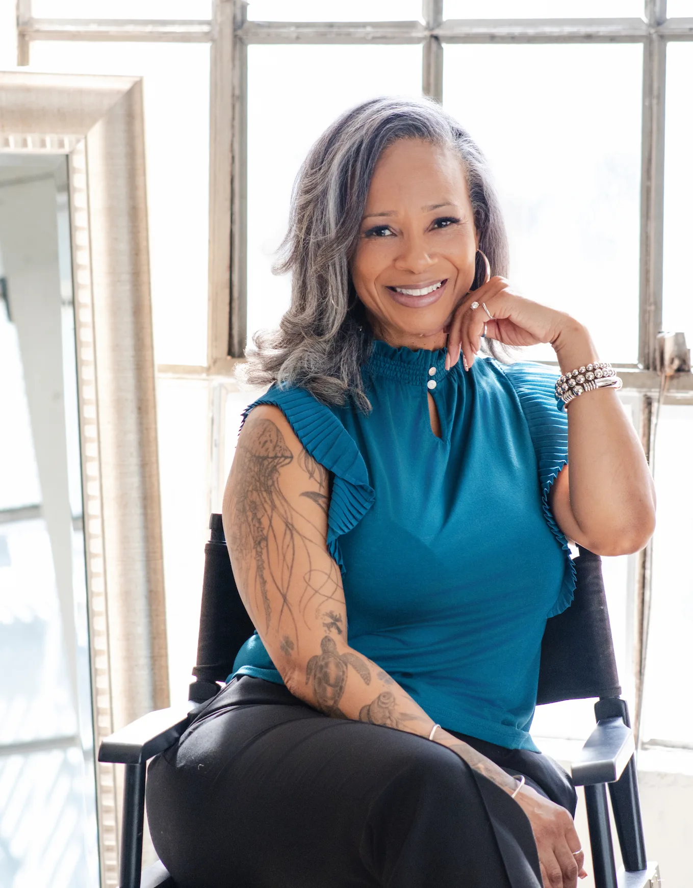 Woman in a calm, reflective pose representing self-awareness and growth illustrating what personal development coaching is and how it works at Taking First