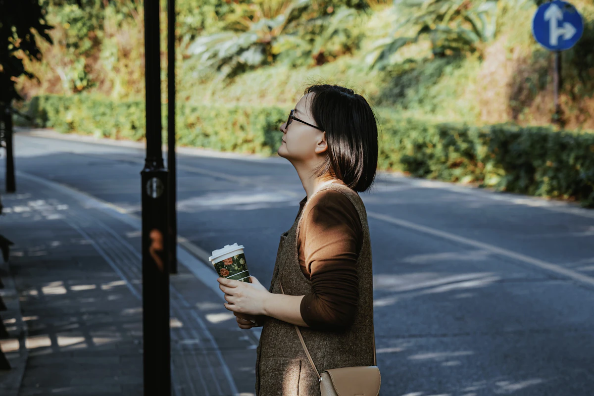 Woman taking a break outside with coffee during the workday to recover from burnout